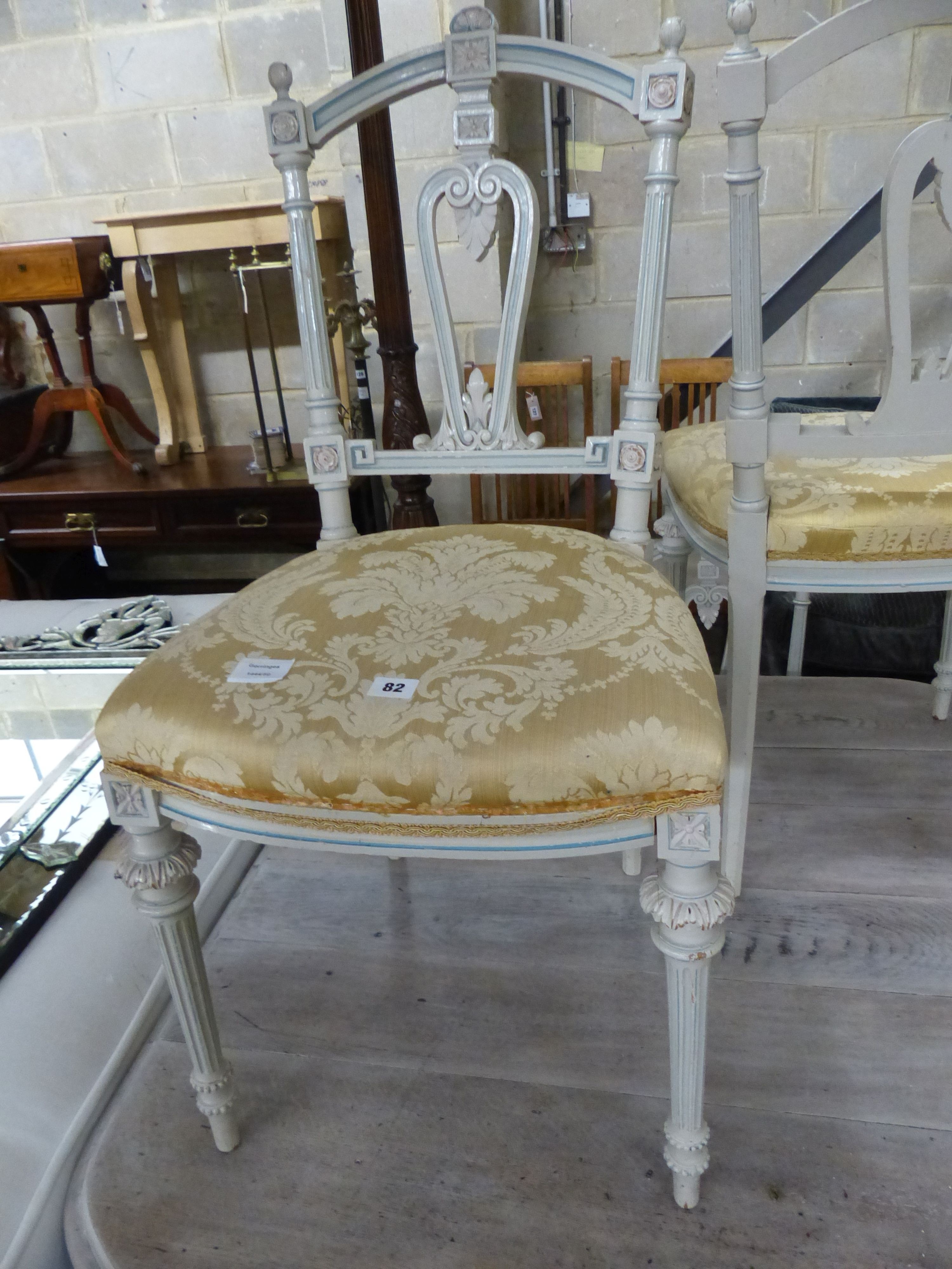 A set of four French light green painted salon chairs